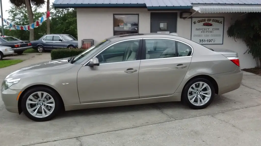 Champagne BMW 5-Series parked in front of the Z Cars of Ocala office